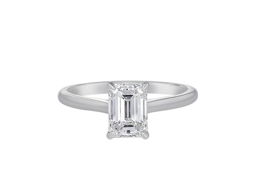 A.G emerald cut diamond solitaire four claw setting with a half round band.