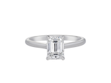 A.G emerald cut diamond solitaire four claw setting with a half round band.