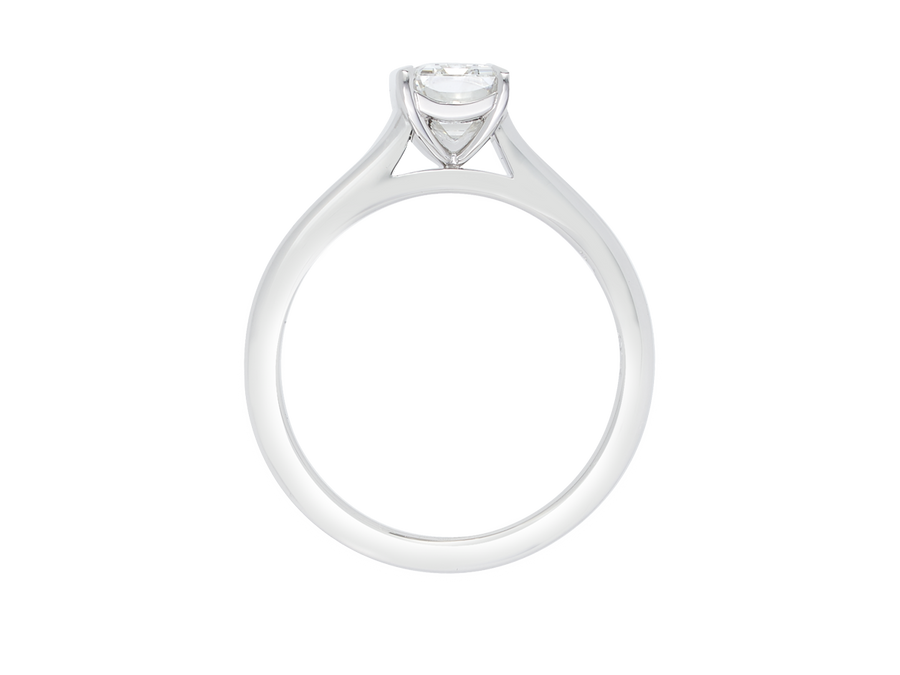 Side view of A.G emerald cut diamond solitaire four claw setting with a half round band.