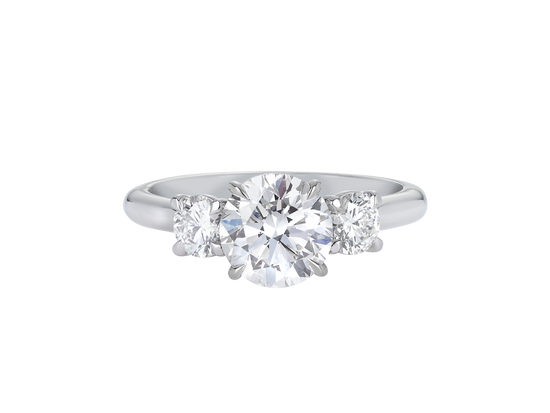 A.G round brilliant cut diamond trilogy four claw setting and half round band in silver. 
