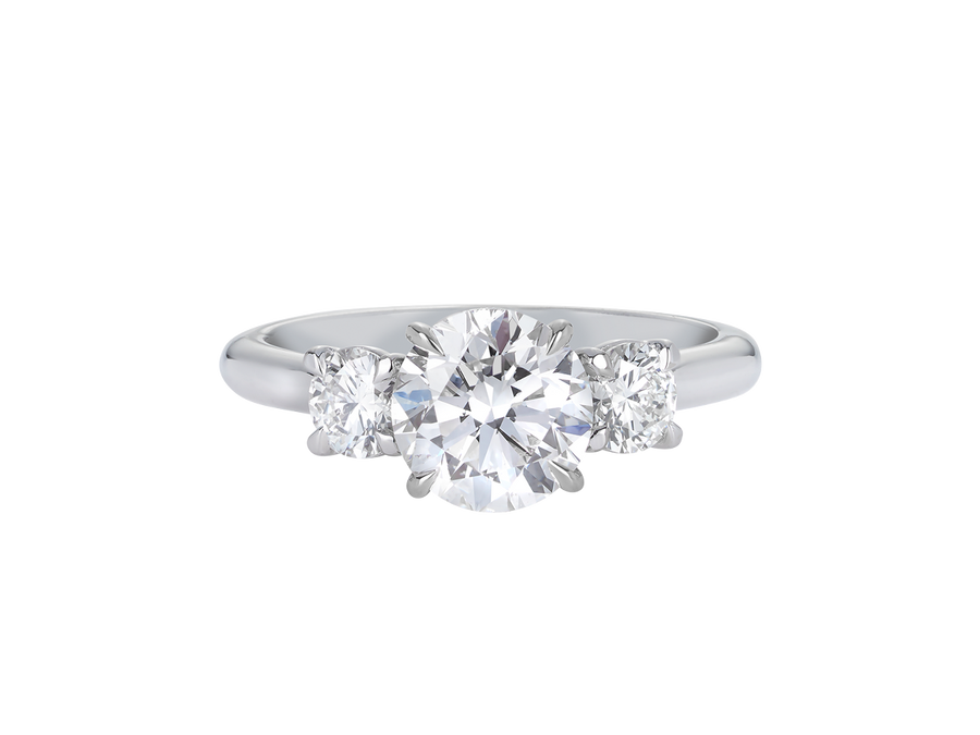 A.G round brilliant cut diamond trilogy four claw setting and half round band in silver. 