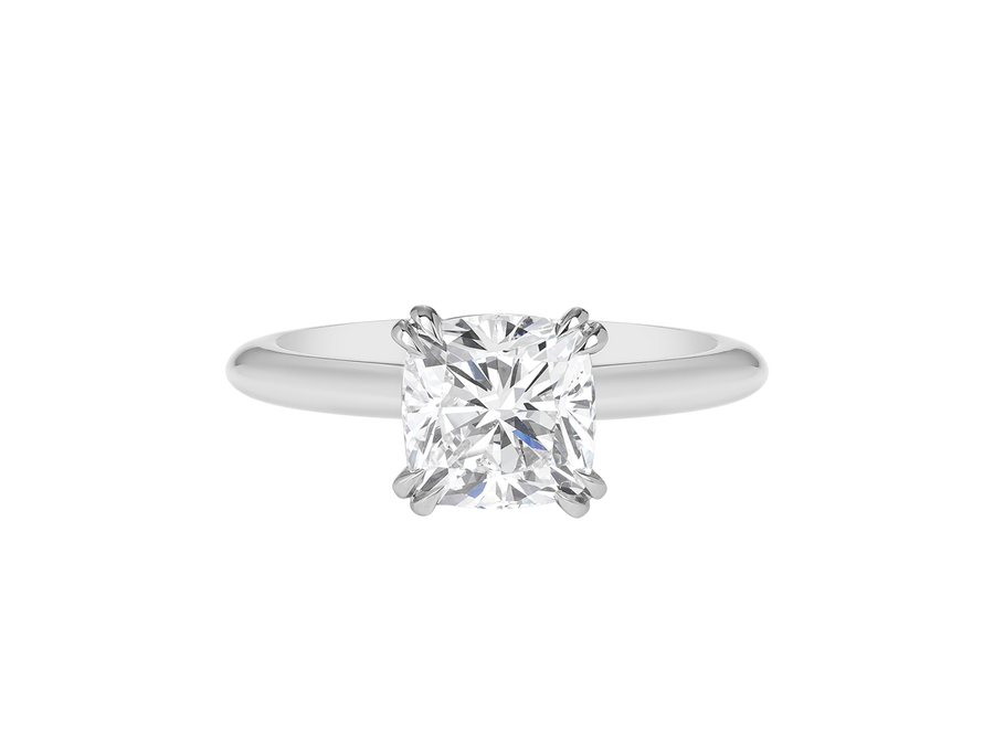 A.G cushion cut solitaire double claw setting with half round band. 