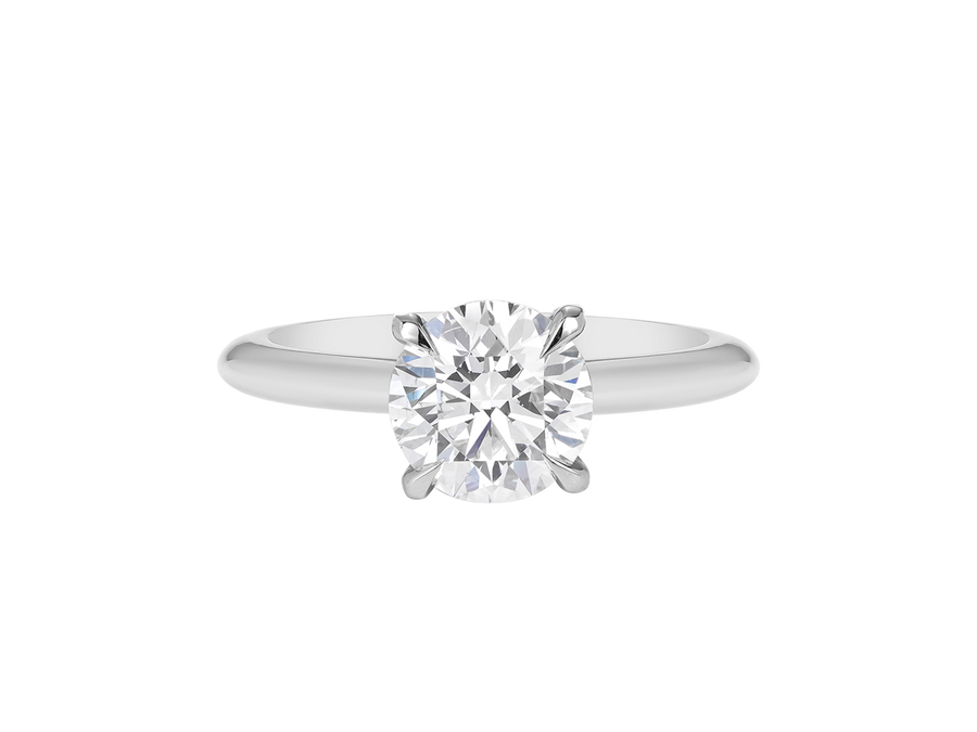 A.G round brilliant cut diamond four claw setting with a half round band.
