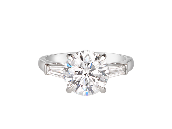 A.G round brilliant cut and tapered baguette diamond trilogy engagement ring. 