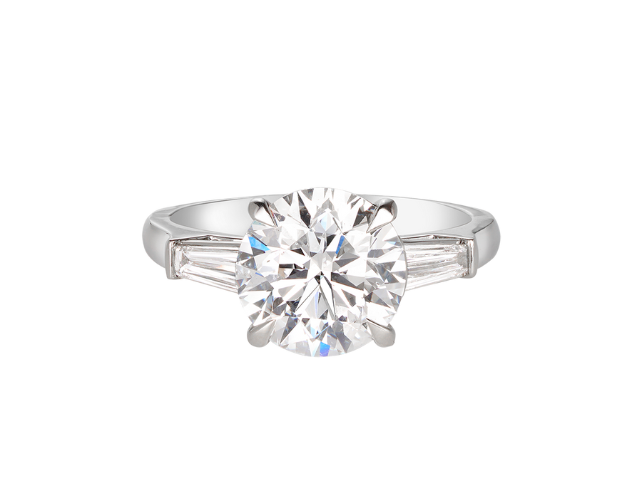 A.G round brilliant cut and tapered baguette diamond trilogy engagement ring. 