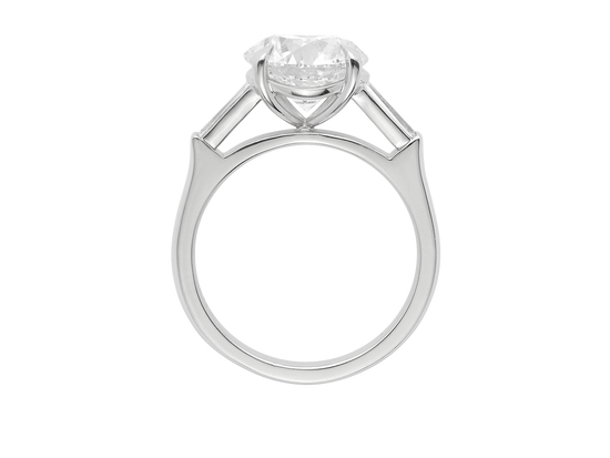 A.G round brilliant cut and tapered baguette diamond trilogy engagement ring. 