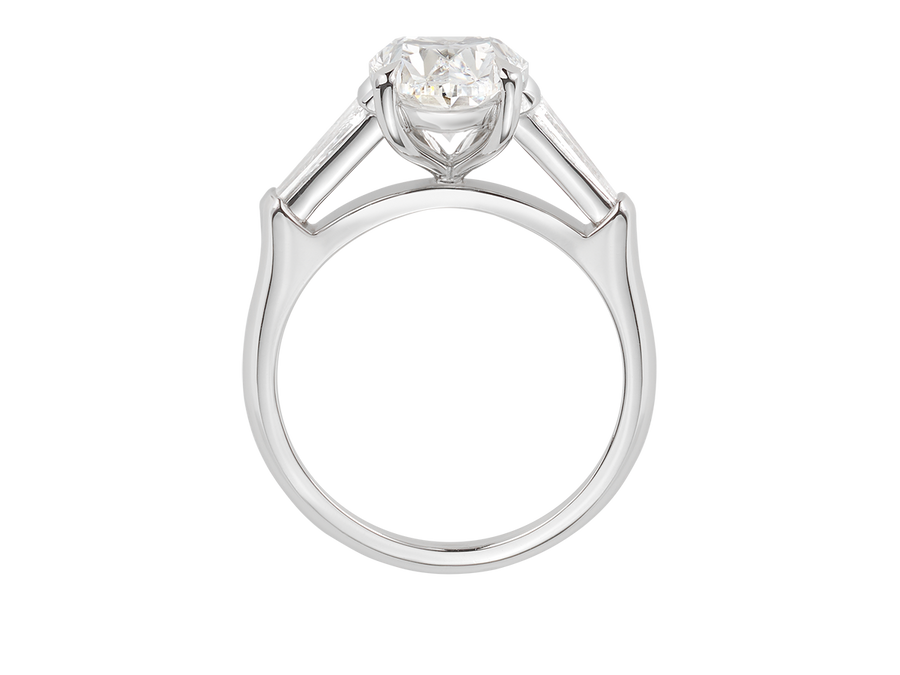 Side view of A.G oval cut and tapered baguette diamond engagement ring. 