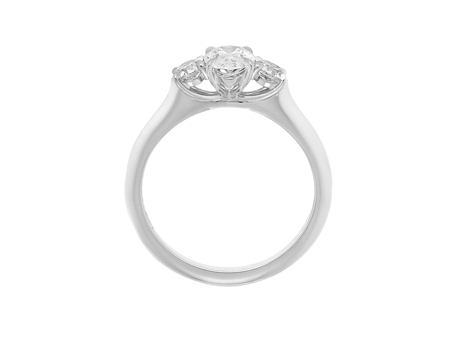 Side view of A.G oval cut and round brilliant cut diamond trilogy ring.