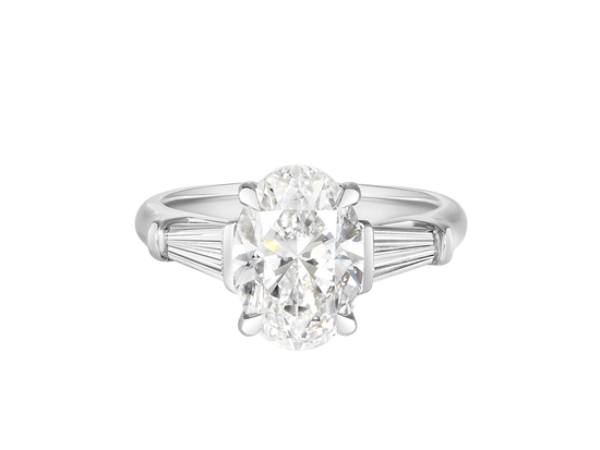 A.G oval cut and tapered baguette diamond engagement ring. 