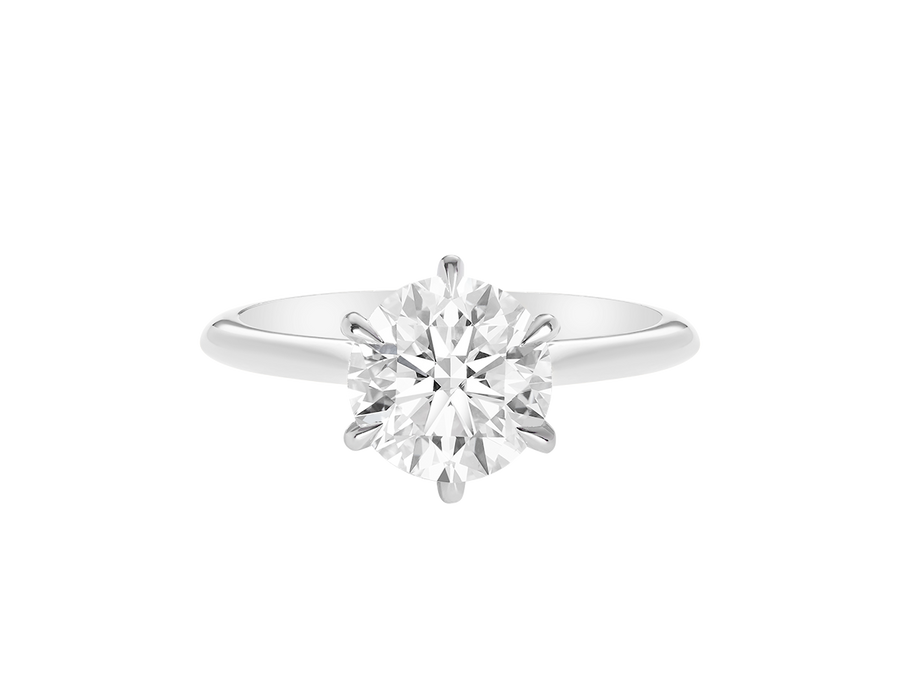 A.G round brilliant cut diamond six claw setting with swept up shoulders and a half round band. 